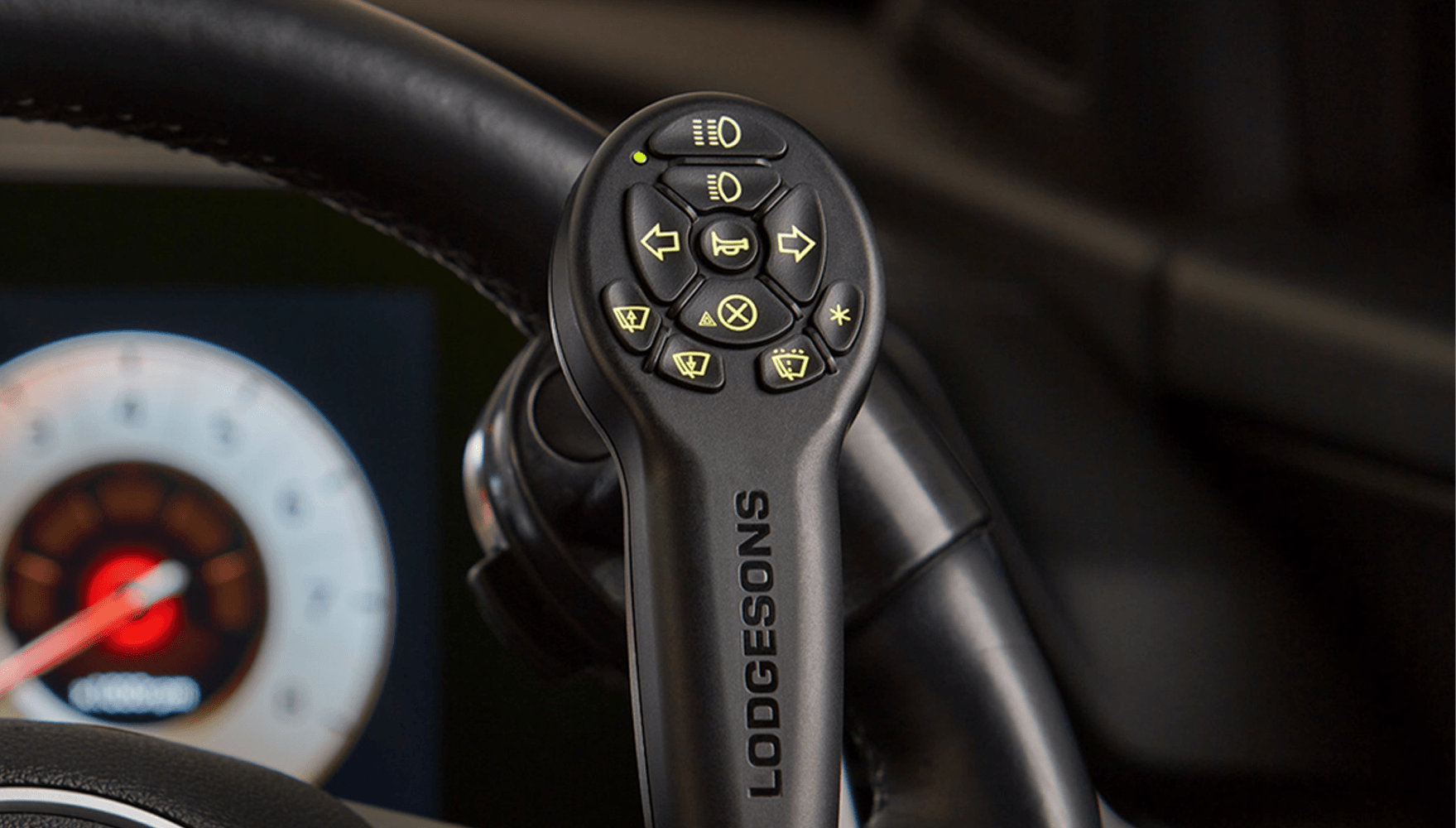 Image of the new EuroGrip product from Lodgesons, mounted to the steering wheel, with keypad showing various options of driving actions.